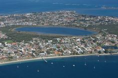 an aerial view of a small town on the water