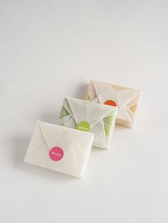 three small envelopes sitting next to each other