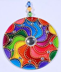 a multicolored circular ornament hanging from a string