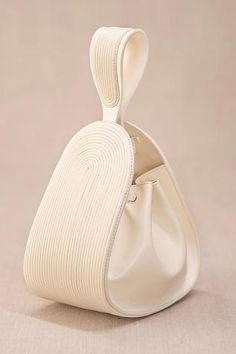 Ivory corded bucket bag in faux leather with corded handle detail.
Composition: Body Material: 100% PU, Faux leather; Lining Material: Poly Suede
Color: White
Card holder with slots and key holder
Cording details
Size (in inches):
Bag: L x W x D: 6.5 x 3.5 x 7.5
Handle Drop: 3.5
Closure: Flat long Drawstring closure - Aza Fashions Potlis Bags, Rope Bags, Pearl Bags, Suede Accessories, Expensive Purses, Canvas Bag Design, Colorful Handbags, Diy Bags Patterns, Stylish Purse