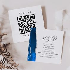 two pieces of paper on top of each other next to a christmas tree and qr code