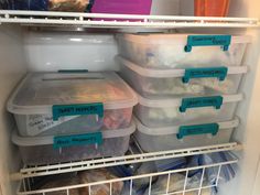 an open refrigerator filled with lots of plastic containers