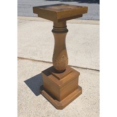 a wooden table sitting on top of a sidewalk