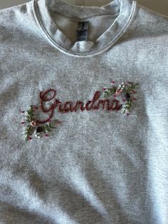 This is a hand embroidered crew neck sweatshirt. Sizes include: small, medium, large, XL, and XXL. The design will stay relatively similar for all orders placed, but colors can be changed to give it a more personal feel. This would be a great gift for a new Grandma/Granny, new Auntie, or anybody that falls in between as I am happy to stitch whatever name/title you may need! I cannot wait to work with you moving forward! Embroidered Grandma Sweatshirt, Embroidery Designs Shirts, Embroidery Designs Sweatshirt, Grandma Sweatshirt, Embroidery Tips, New Grandma, Embroidery Sweatshirt, Embroidered Crewneck, Shirt Embroidery