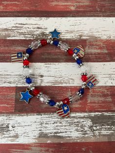 This is a Patriotic Charm Bracelet. It would make a great addition to a woman or teen's 4th of July outfit. It would make a great gift for the 4th of July. It has clear, red, and blue beads. It has small silver balls. It has silver spacing beads. It has two heart American flag charms. It has two American flag charms. It has two blue star charms. It was made with sturdy stretch string.  It fits most women and teens. It stretches to fit on the wrist. All items are ready to be shipped I do combined shipping. Items ship in 2-5 business days. Check out more items at: http://www.etsy.com/shop/MesheleCrafts  https://www.facebook.com/MesheleCrafts Adjustable Patriotic Stretch Bracelet Gift, Cheap Adjustable Patriotic Stretch Bracelet, Handmade Adjustable Patriotic Bracelet, Patriotic White Stretch Bracelet, Red Patriotic Bracelet Jewelry, 4th Of July Outfits, Two Hearts, Blue Star, Star Charms