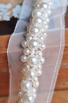 a close up of a white beaded bracelet