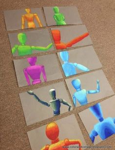 paper cut out of different colored figures sitting on the floor