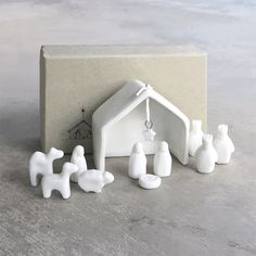 a nativity scene is shown in front of a gift box with its contents on the table