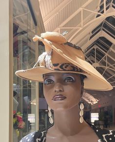 A tan felt hat open crown felt hat . This is a great hat for up dos and dreadlocks. The felt hat is accented with cowrie shells, kuba cloth, two-tone feathers and leopard hat band. This is a cool look that has class and style . You will surely turn heads with this beauty. This is great for Winter  when you add a scarf and the Spring. Don't  delay order yours today. Fitted Beige Felt Hat For The Beach, Beige Brimmed Hat Bands For Kentucky Derby, Brown High Crown Hat For Kentucky Derby, Adjustable Beige Costume Hat With Short Brim, Adjustable High Crown Felt Hat For Fall, Beige Brimmed Felt Hat For Kentucky Derby, Beige Felt Hat For Kentucky Derby, Beige Felt Hat For Kentucky Derby And Country Events, Beige Felt Hat For Rodeo And Kentucky Derby