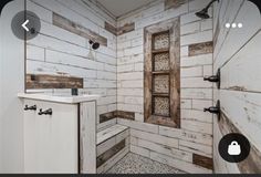 a bathroom with white tile and wood accents on the walls, along with an open window