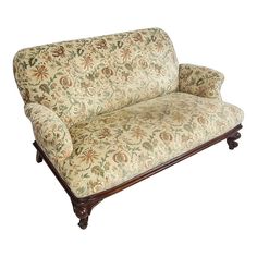 a couch that is sitting on top of a wooden frame with a floral print upholster