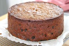 a chocolate cake sitting on top of a cooling rack