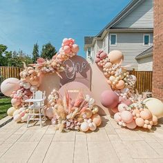 an outdoor area decorated with balloons and flowers