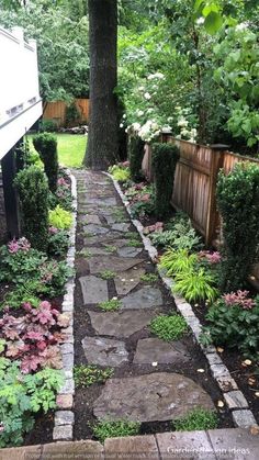 a stone path in the middle of a garden