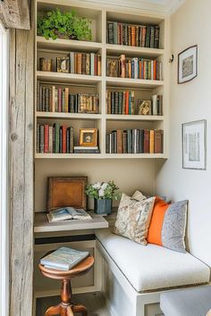 a white bench sitting in front of a book shelf filled with books