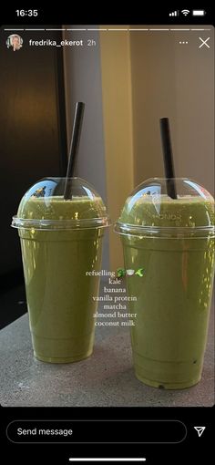 two plastic cups filled with green smoothies