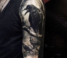 a man with a black and white tattoo on his arm has a crow in the tree