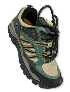 a pair of hiking shoes with laces on the outstretches and soles