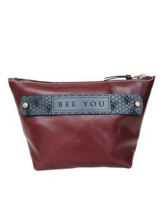 The Cordovan Bee You Evelyn Pouch offers a stylish, practical solution to ensure your items stay organized, whether you're traveling, storing makeup, or simply keeping small items in your tote or carry on. . Front Tab: Bee You Dimensions: Body: top width 11.5 x 7.5”HInside pocket: 5”H x 7”W . #10 YKK zipper closure Rectangular Travel Pouch With Case, Modern Travel Pouch With Case Included, Cosmetic Bag With Luggage Sleeve Pouch, Versatile Travel Bags With Case Included, Functional Cosmetic Bag With Zipper Pouch As Gift, Rectangular Cosmetic Bag With Case For On-the-go, Functional Cosmetic Bag With Zipper For Gift, Functional Zipper Pouch For Gifts, Functional Pouch Cosmetic Bag As Gift