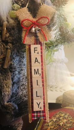 a christmas ornament with the word family hanging from it's front door