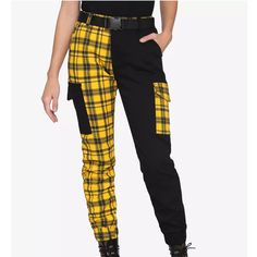 No Longer Sold On Website Your Cargo Joggers Just Got A Whole Lot Edgier! This Pair Of Joggers Is Split Down The Middle, Half Solid Black And Half Yellow Plaid, With Contrasting Utility Pockets On Both Sides. Comes With Hip Pockets And A Removable Utility Buckle Belt. Elastic Waistband And Ankle Cuffs. 98% Cotton; 2% Spandex Wash Cold; Dry Low Rise: 11" Inseam: 27 1/2" Leg Opening: 5" Imported Listed In Junior Sizes Reasonable Offers Are Welcome Additional Photos/Measurements Upon Request Ships Next Business Day From A Smoke And Pet Free Home Bundle 2+ Items For A Personal Discount And Only Pay One Shipping Fee Check Out My Page For These Brands: Vans, Nike, American Eagle, Zara, Emo Sanrio, Utility Buckle, Victorious Secret, Anime Gamer, Tripp Pants, Androgynous Outfits, Cargo Jogger Pants, Yellow Clothes, Black Punks