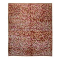 an antique rug with red and yellow colors