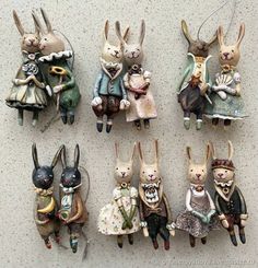 several figurines of rabbits dressed in costumes