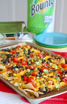 a casserole dish filled with nachos and cheese