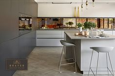 a kitchen with two stools next to a counter top and an island in the middle