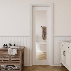 a bathroom with white walls and tile flooring