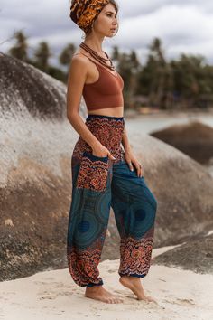 Teal and peach boho trousers with mandala pattern * Made from 100% rayon * Lightweight and comfortable * Elasticated ankles and waistband   * Small Length - 40"/ 100cm Waist - 22"/ 57cm - 44"/ 111cm * Medium/Large Length - 40"/ 101cm Waist - 30"/ 76cm - 53"/134cm * Small fit most UK ladies size 6-10 (US 2-6) * Medium/Large fit most UK ladies 12-16 (US 8-12) Bohemian Pants With Pockets For Festivals, Bohemian Bottoms With Pockets For Vacation, Bohemian Bottoms With Elastic Waistband For Vacation, Bohemian Long Pants With Pockets, Bohemian Harem Pants With Pockets, Casual Boho Print Harem Pants For Vacation, Boho Print Harem Pants For Summer Vacation, Hippie Boho Print Vacation Bottoms, Bohemian Harem Bottoms With Pockets