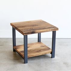 a wooden table sitting on top of a cement floor