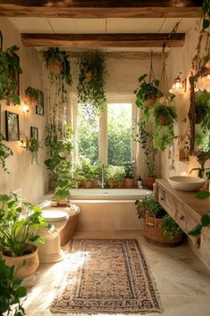 a bath room with a tub a sink and lots of plants in the window sill