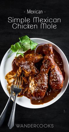 a white plate topped with meat covered in sauce and garnished with cilantro