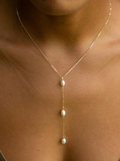 Pearl Lariat Necklace, Good luck charm, Bridesmaid Gifts, Christmas gift, Gold Y Wedding Necklace This is a delicate and dainty lariat necklace that you can wear everyday! 💕Details: Length Of Drop: 4inch roughly  Length 18" Longest Length Can Be Shortened With Adjustable Pully To Any Length  Pearl Size: 5x8mm Chain Type: Cable Chain  High quality gold plated  sterling silver 925 necklace with real fresh water pearls . 100% hypoallergenic-totally safe for skin 🎁 Package All of our jewelry arrives carefully packaged in a free gift jewelry bag. It's ready for gifting. 👑Protection 💙Clean your gold plated jewelry with a cotton ball or a very soft cloth to remove dust and restore shine. 💙Keep your jewelry separate from other types of jewelry to avoid scratches. 💙Do not spray on perfume or Lariat Necklace Wedding, Pearl Lariat Necklace, Pearl Lariat, Luck Charm, Jewelry Bag, Luck Charms, Silver 925 Necklace, Water Pearls, Cotton Ball