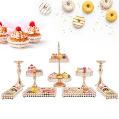 an assortment of pastries and desserts displayed on trays in front of a white background