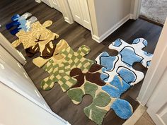 several rugs on the floor in front of a door with an elephant and giraffe design