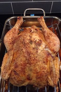 a whole chicken sitting on top of a metal pan