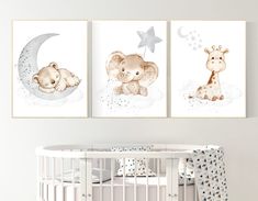 two pictures of animals are hanging on the wall next to a crib in a baby's room