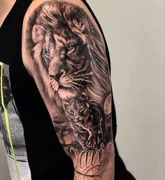 a man with a lion and tiger tattoo on his arm