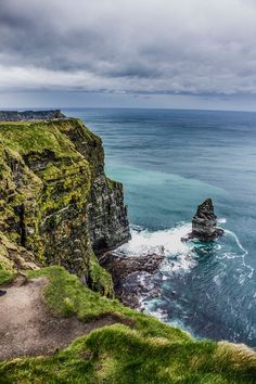 the cliffs are covered in green grass and water