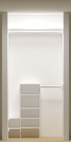 an empty room with white walls and shelves