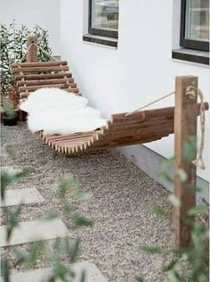 a wooden bench sitting next to a building