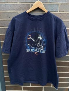 "Vintage 1990s Chicago Bears NFL Graphic T-Shirt - Size XL (Length 28.5\", Chest 23\") - Overall great vintage condition (no holes/no stains) - Message me for more information Please take note of the measurements listed as these are vintage clothes and may fit different than the tag size. Follow our page for more vintage clothing drops! Connect with us on Instagram: @recurarchives" 90s Style Short Sleeve Sports T-shirt, 90s Style Screen Print Tops For Sports Events, 90s Logo Print Tops For Sports Season, 90s Graphic Print Sports Top, Throwback Graphic Print Short Sleeve Tops, Throwback Style Short Sleeve Graphic Print Tops, Throwback Style Short Sleeve Tops With Graphic Print, Vintage Graphic Print Fan Gear T-shirt, Vintage Fan Gear T-shirt With Graphic Print