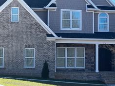 a large brick house with white trim and windows