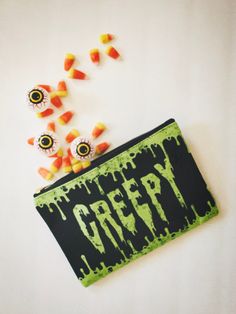 This oozing slime pouch is a perfect accessory for every creepy goon this haunting season. These pouches are perfect for a weekend trip or to carry any of your little odds and ends on the daily. Accessory bag is 100% polyester outer with laminate inner lining. Black zipper enclosure and gold zipper puller. Available in two sizes. ◆ S: 8.35 in. x 5.99 in. ◆ L: 11.82 in. x 8.35 in. Original design created for ShadowCult, printed and shipped in the US. ☟CANCELLATIONS & REFUNDS☟ I partner with a print provider who handles the printing and shipping for me. Once an order is placed, there's a chance I won't be able to alter or cancel it with the print provider. PLEASE confirm your shipping and SIZE information is correct before submitting an order. Each item is printed to order and therefore cann Horror Aesthetic, Pouch Makeup, Coin Purses, Purse Pouch, Gold Zipper, Spooky Halloween, Drink Sleeves, Makeup Bag, Original Designs