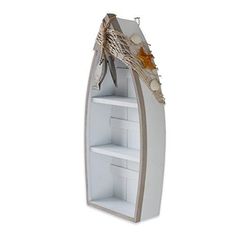 a boat shaped book shelf with seashells and starfish on the top, in front of a white background