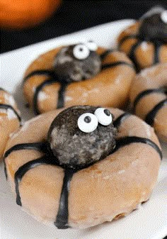 doughnuts with eyes and googly eyes on them sitting on a white plate