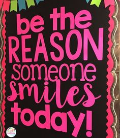 a sign that says be the reason someone smiles today on black paper with pink lettering