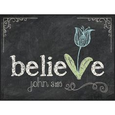 a chalkboard sign with the words believe and a flower on it's side